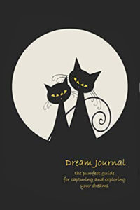 dream journal with two black cats sitting close together before a full white moon